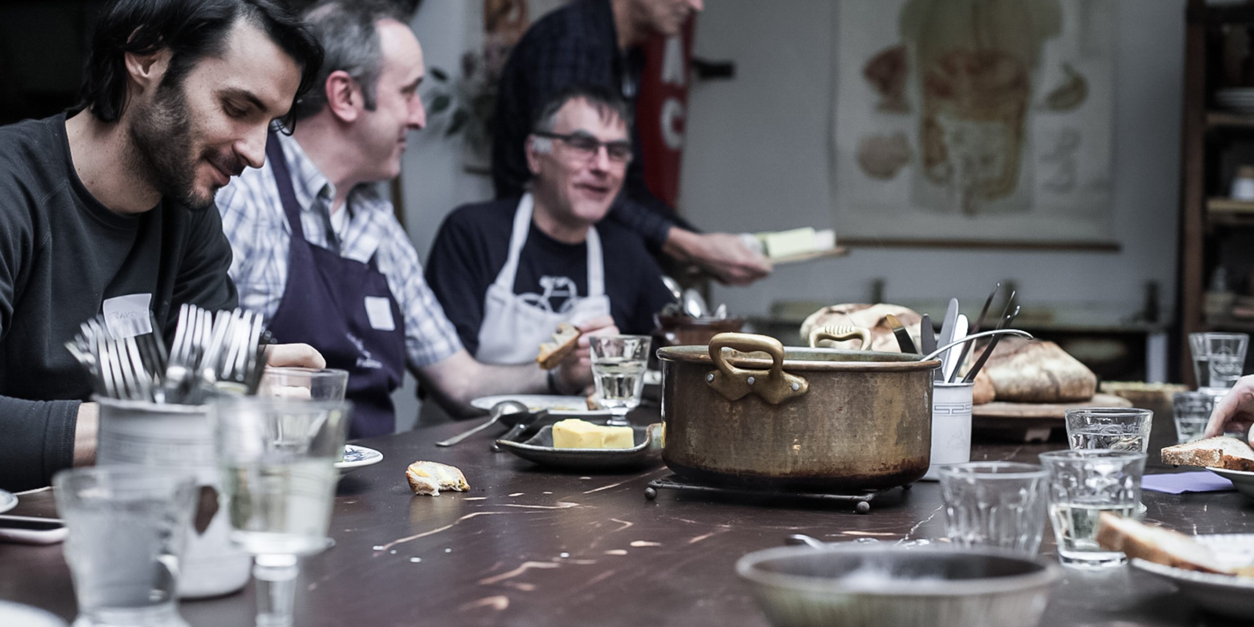 People at the table eating and enjoying healthy bread at the table, showcasing the role of quality bread in supporting digestion, gut health, and overall well-being